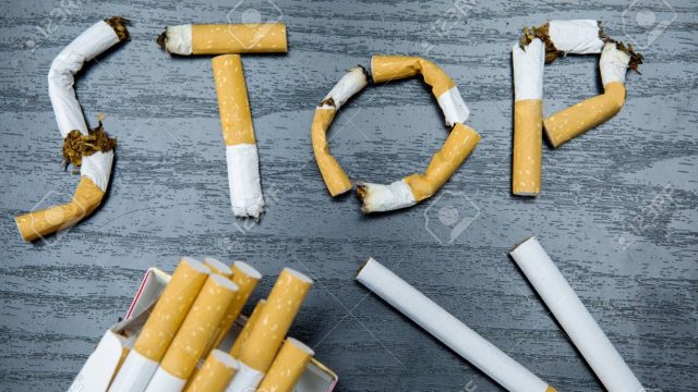 77752546-concept-for-quitting-smoking-close-up-of-a-cigarette-pack-and-stop-smoking-sign-on-the-table.jpg