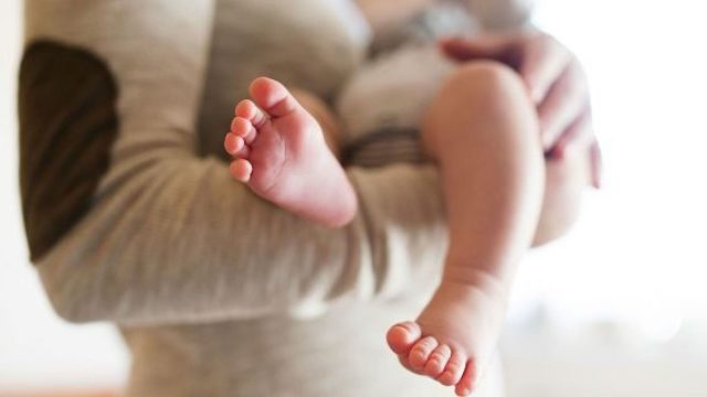 babyholdfeetistock.jpg